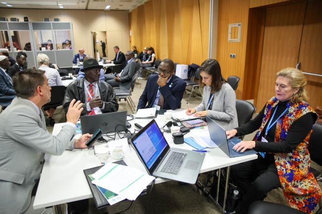 Delegates discussing Chad's proposal 