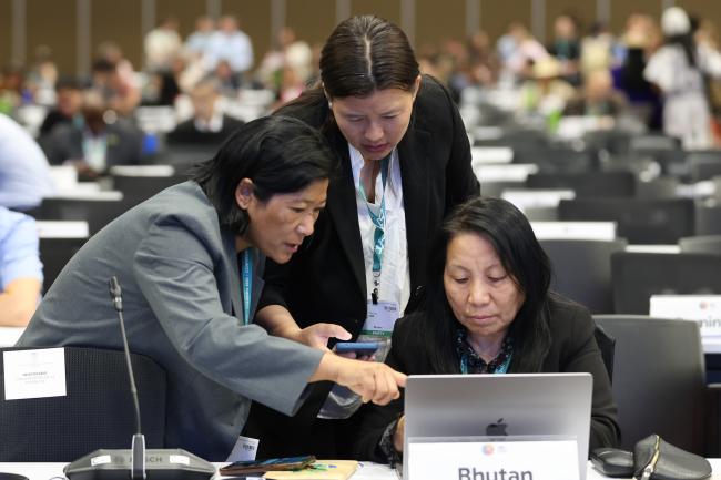 Delegates from Bhutan conferring before the opening plenary