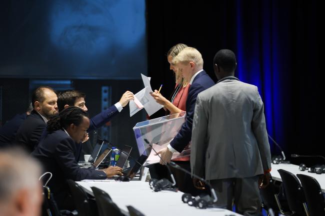 Secretariat members and tellers collect the ballots 