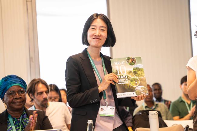 Hyunju Lee, Korea Forest Service, with the FERI at 10 years reportFERI forests-23oct24-photo