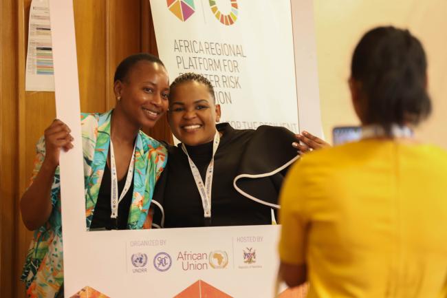 Delegates pose for photos between sessions