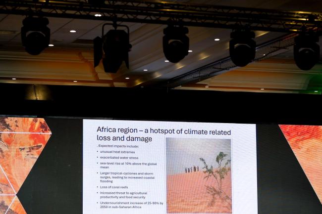 A slide highlights how Africa is a hotspot for climat-related loss and damage 