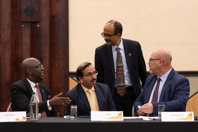 Kamal Kishore, Special Representative of the UN Secretary-General for DRR, and Head, UNDRR, consults with delegates during the session