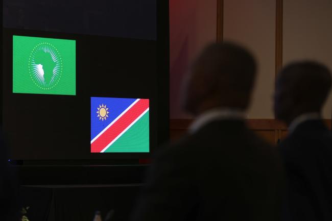 Delegates stand for the Namibian national anthem