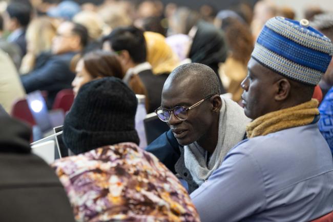 Delegates consult during the session