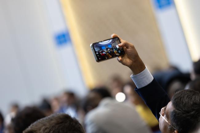 A delegate takes a photo during the contact group