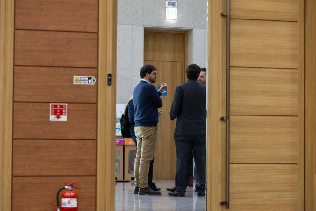 Delegates consult in the corridors