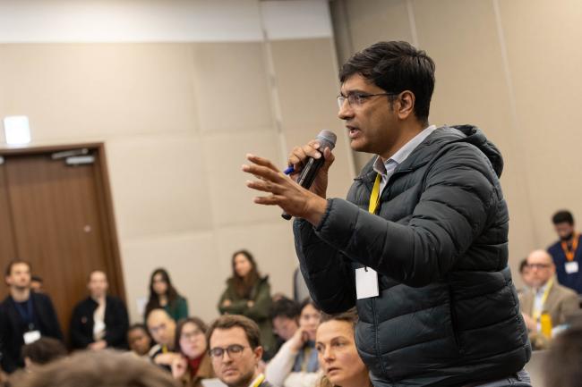 Journalists ask questions from the floor