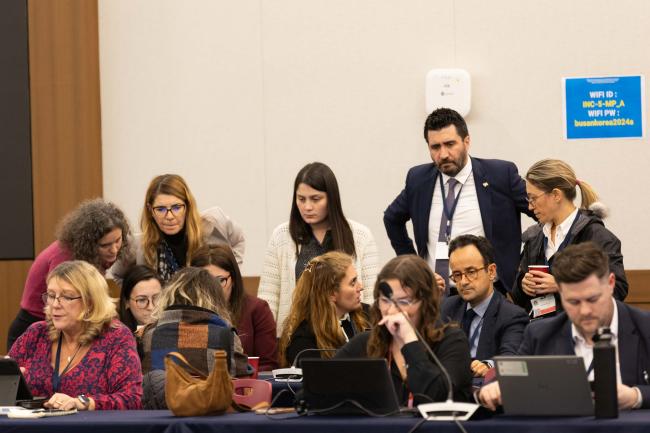 Delegates consult as the new text is released