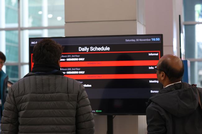 Delegates check the live schedule regularly to try keep track of the informal consultations taking place