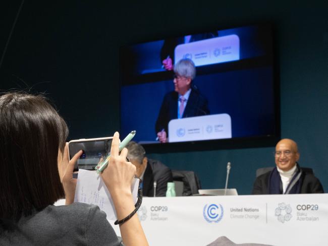A participant taking a picture of the panel