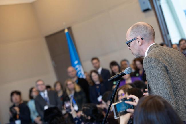 Journalists ask questions from the floor