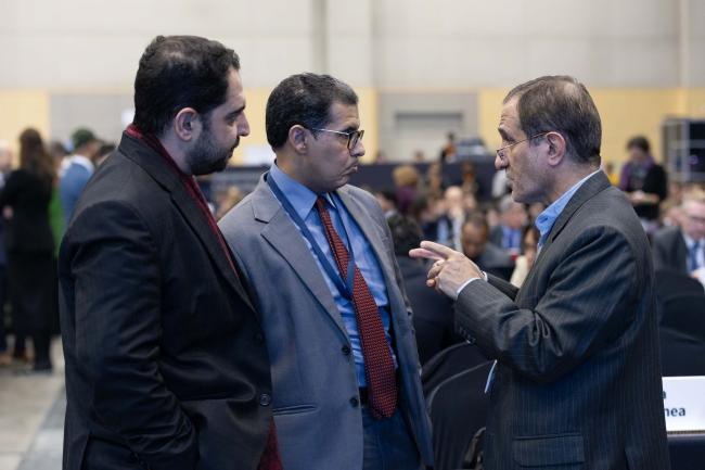 Delegates from Iran and Kuwait consult