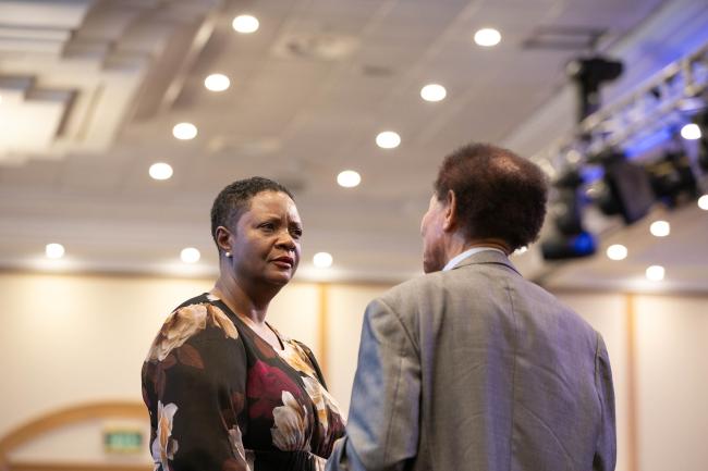 Delegates speak informally before the start of plenary