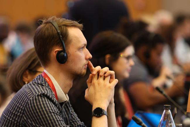 Delegates follow the deliberations