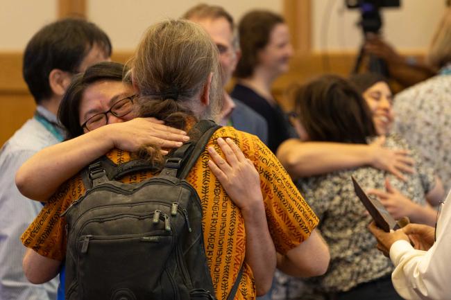 Coordinating Lead Authors share a moment of relief as work is agreed to