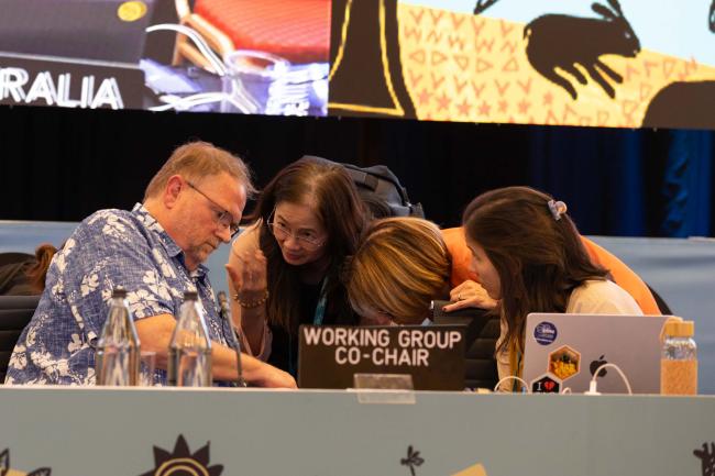 Douglas Beard, Working Group 1 Co-Chair, consults with the legal team
