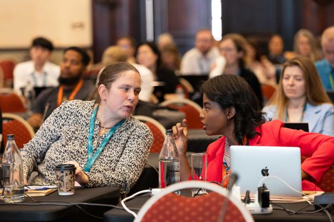 Delegates from Norway and Haiti consult