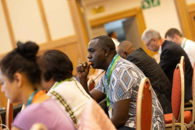 Delegates listen during the session
