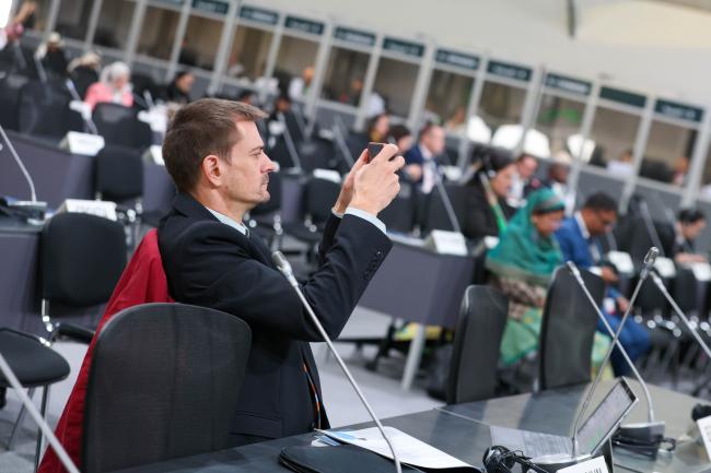 A delegate taking a picture 