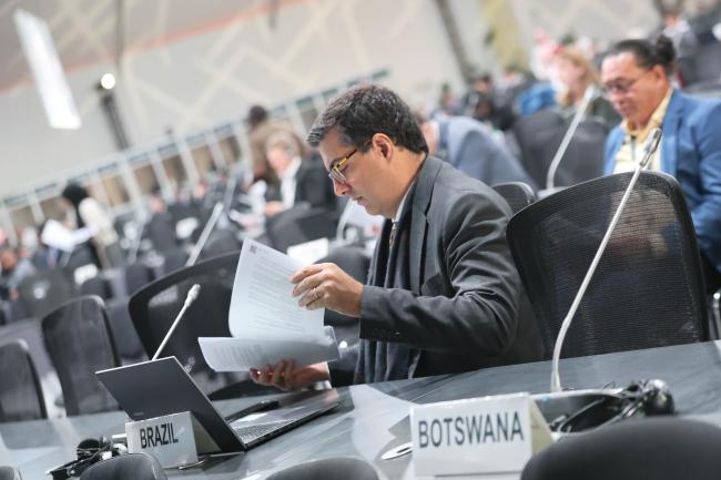 Delegates review decision documents.