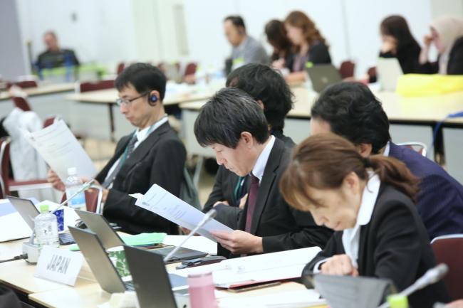 Delegates from Japan reviews the documents.