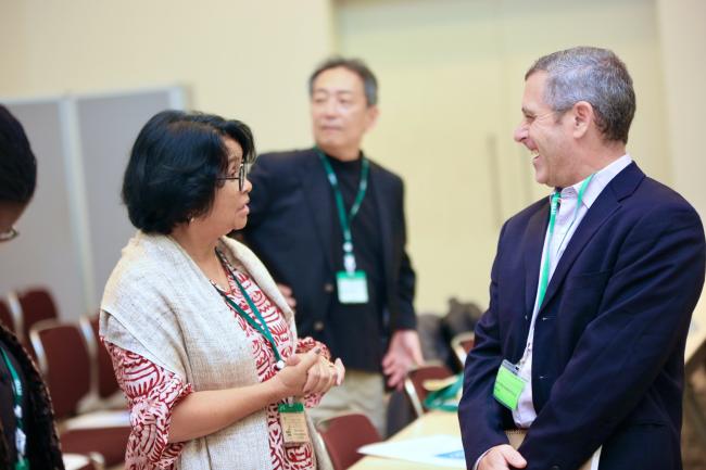 Participants engage in a lively discussion during the ITTC60 session, fostering collaboration and idea exchange.