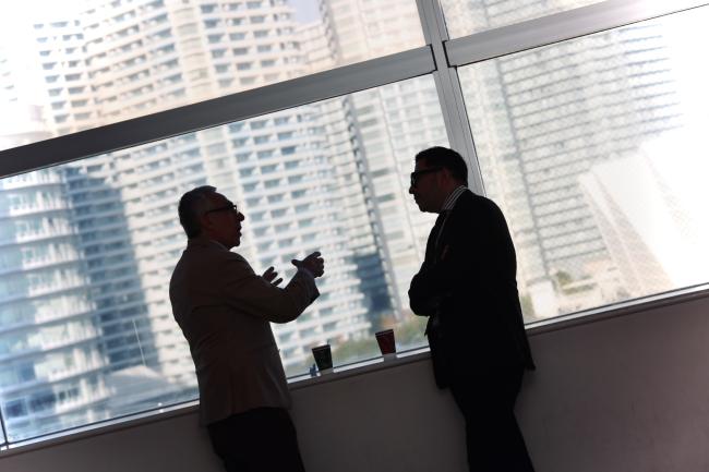Participants talking by the window.