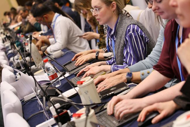 Delegates taking notes during the plenary 