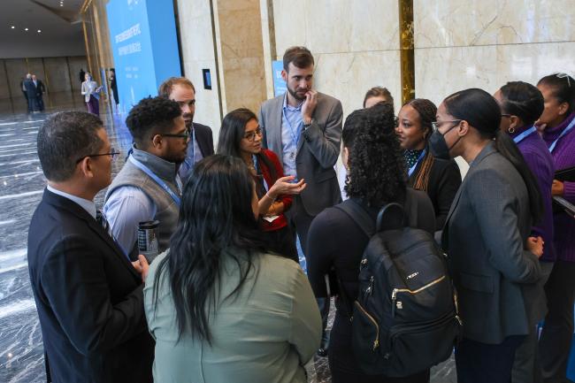 Delegates consult in the corridors.