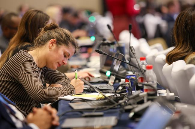 A delegate taking notes 