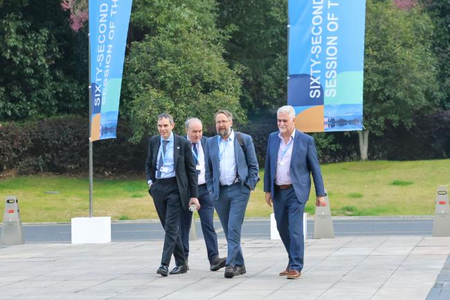 Delegates walk through the venue during a break 