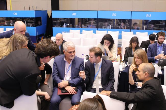 Delegates consult between the sessions.