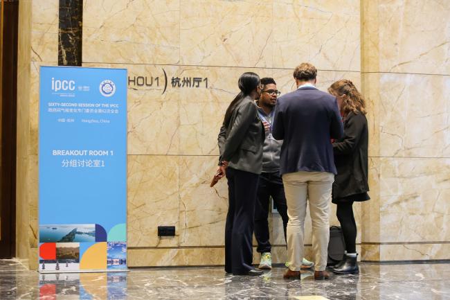 Delegates consult in the corridors.