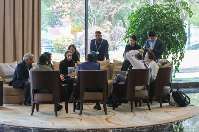 Delegates consult in the corridors. 