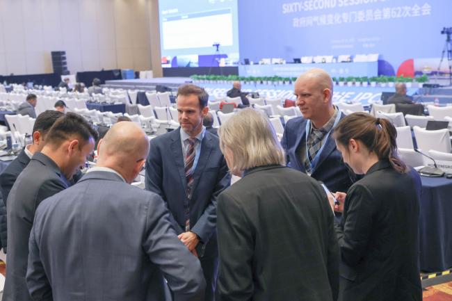 Delegates consult during a break 