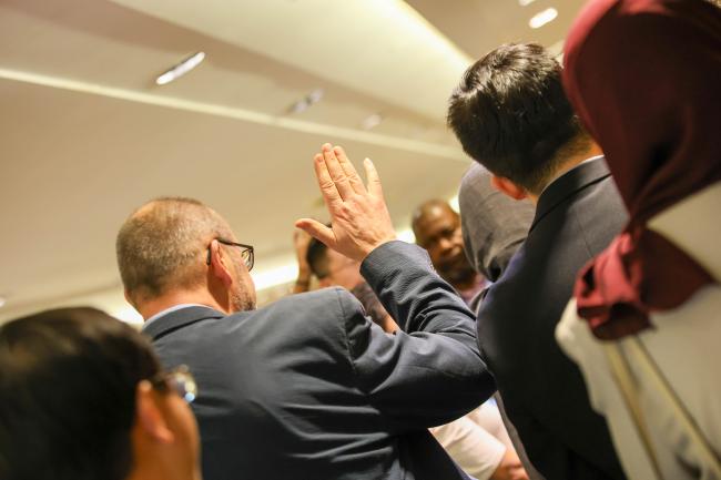 Raising hand to speak in a huddle