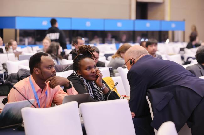 Delegates discuss during the session.