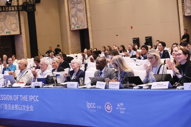 Delegates applaud following the closing of the IPCC-62 session. 