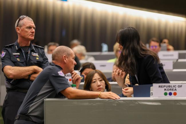 Members of the United Firefighters Union of Australia, conferring with delegates from the Republic of Korea