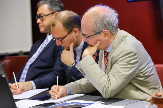 Speakers taking notes 