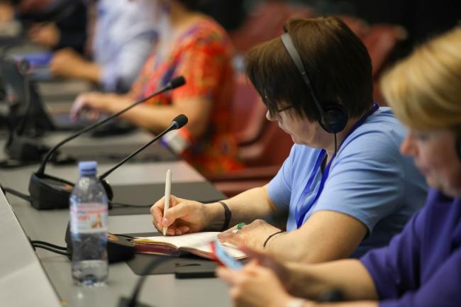 A delegate taking notes 