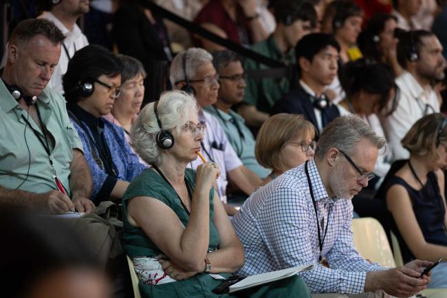 Delegates listen to discussions throughout the day
