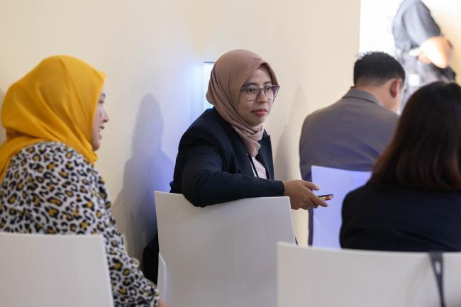 Delegates speak informally during the session