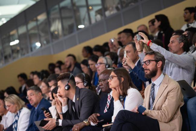 Delegates listen to the interventions