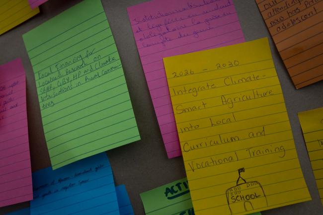 Following an interactive session, delegates write their hopes for gender responsive actions in the future