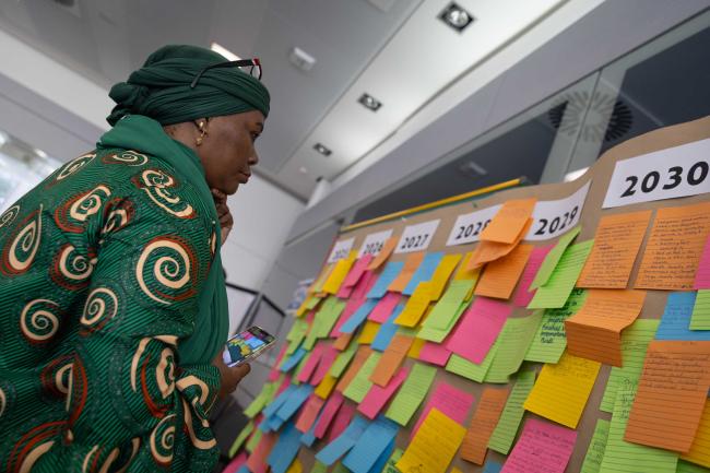 A delegate looks at the visioning board for future gender action plans