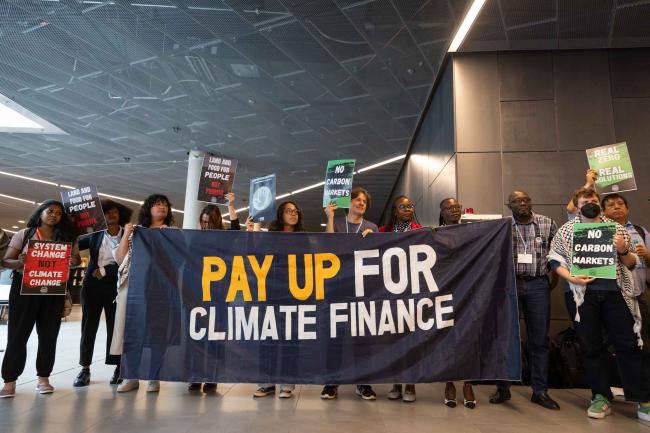 Members of civil society demonstrate in the corridors, calling for greater action on climate finance