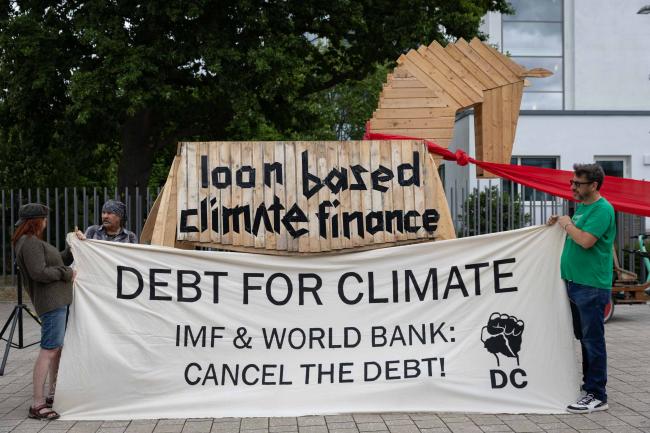 As the second week of SB 62 begins, members of civil society demonstrate outside the venue, calling for loan based climate finance to be stopped and for debt to be cancelled