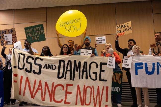 Members of civil society demonstrate to remind delegates of the urgent need to remember loss and damage, calling for greater inclusion in nationally determined contributions and to make funding available